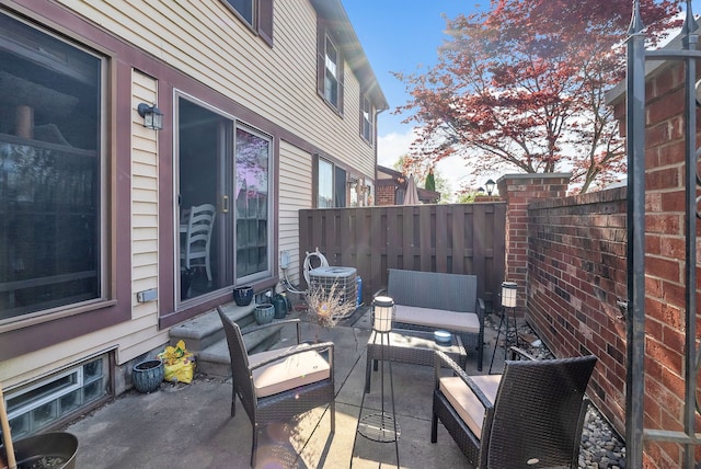 view of patio / terrace with an outdoor hangout area, fence, and central AC unit