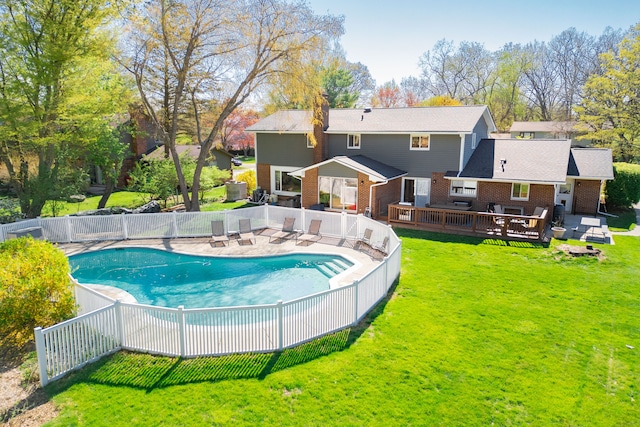 view of pool with a fenced in pool, a wooden deck, a yard, and fence