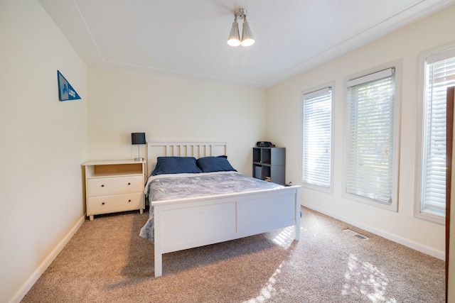 bedroom featuring carpet flooring, baseboards, and visible vents