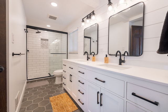 bathroom with a sink, a shower stall, and recessed lighting