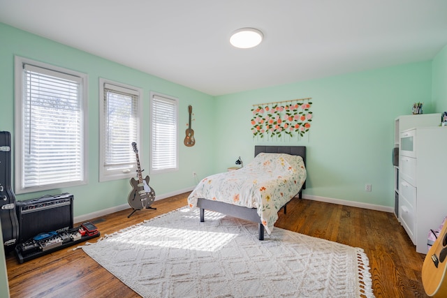 bedroom featuring baseboards and wood finished floors