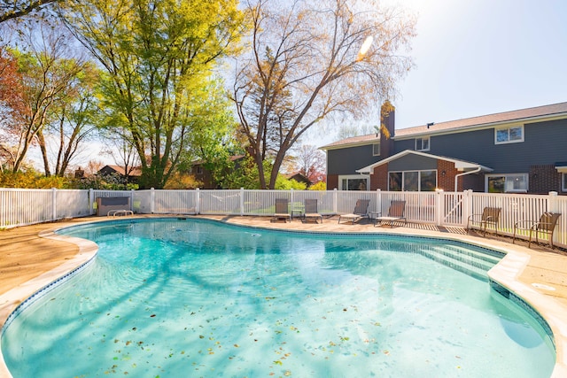 view of swimming pool with a fenced in pool and fence