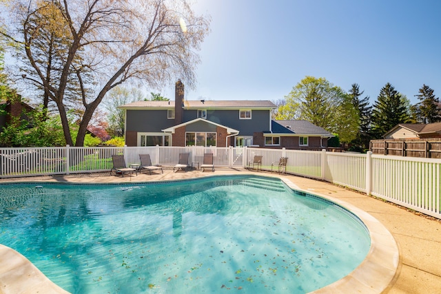 view of swimming pool featuring a fenced in pool and fence