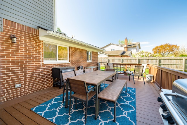 wooden deck with fence and outdoor dining space