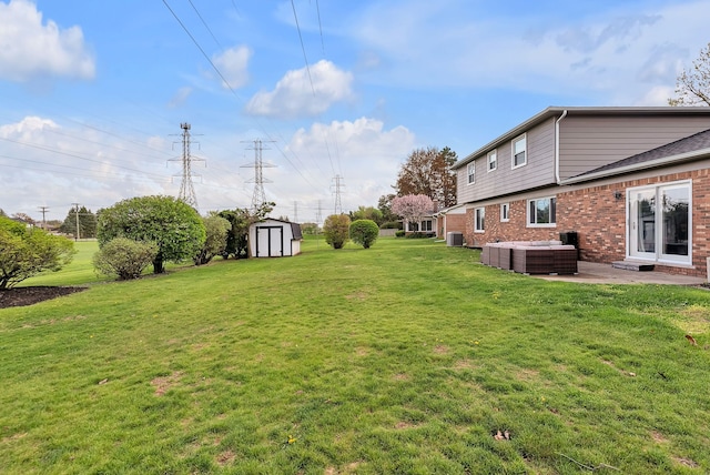 view of yard with a storage shed, a patio, an outdoor structure, and central AC unit