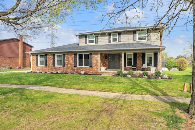 view of front of home featuring covered porch, brick siding, a front yard, and roof with shingles