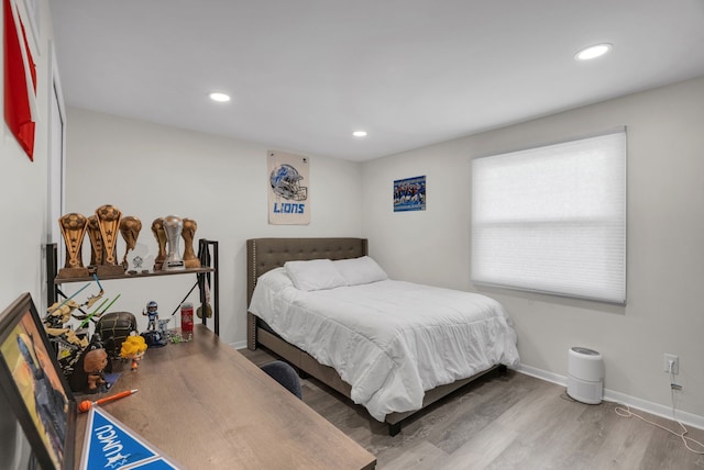 bedroom with recessed lighting, baseboards, and wood finished floors