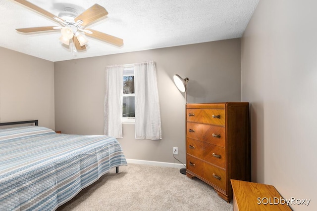 bedroom featuring baseboards, a ceiling fan, and light colored carpet