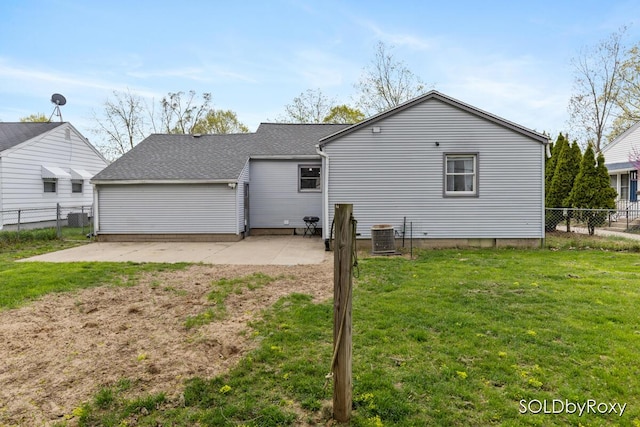 rear view of property with a fenced backyard, a yard, a patio area, and cooling unit