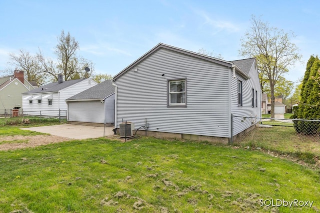 exterior space with fence, a patio, a yard, and central AC
