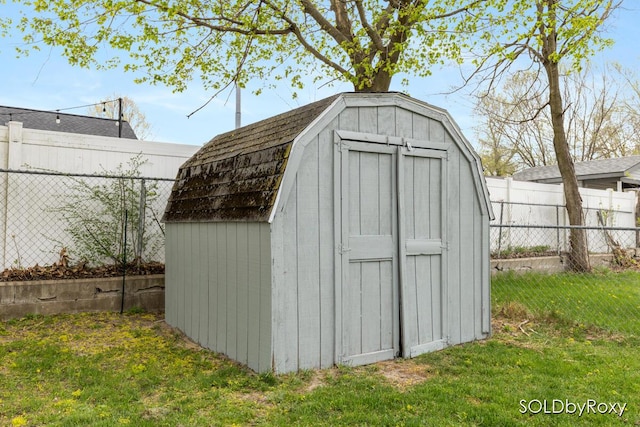 view of shed featuring fence