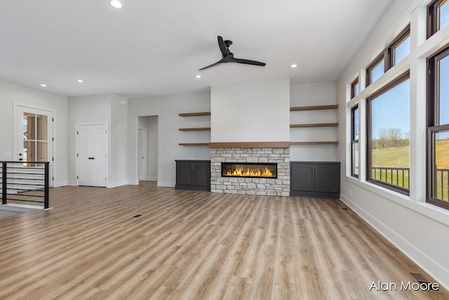 unfurnished living room featuring recessed lighting and a healthy amount of sunlight