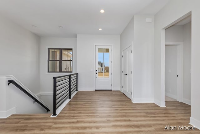 entryway with recessed lighting, baseboards, and light wood-style flooring