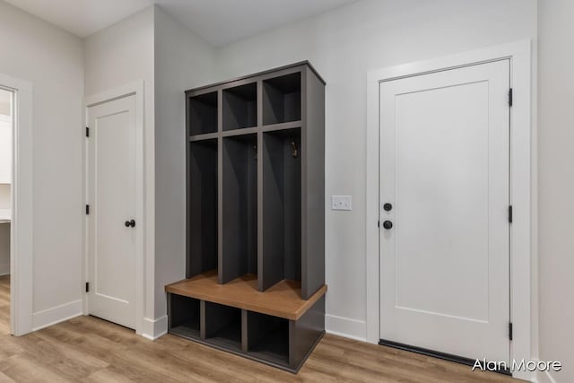 mudroom featuring baseboards and light wood-style floors