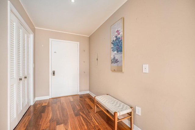 hall featuring baseboards, ornamental molding, recessed lighting, and wood finished floors