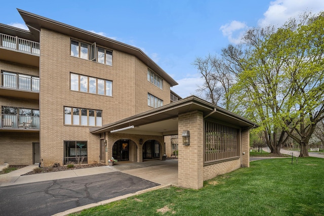 view of building exterior with a carport and driveway