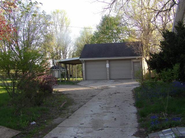 garage featuring concrete driveway