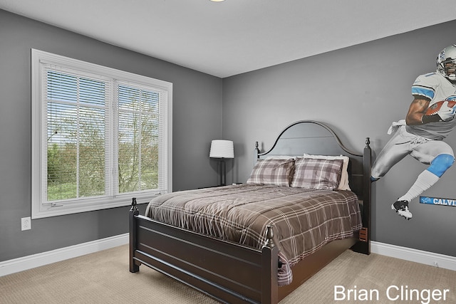 carpeted bedroom featuring baseboards