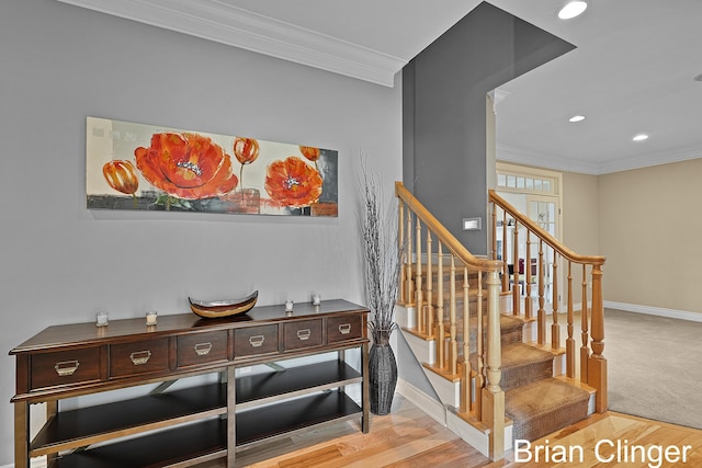 stairway with recessed lighting, baseboards, ornamental molding, and wood finished floors