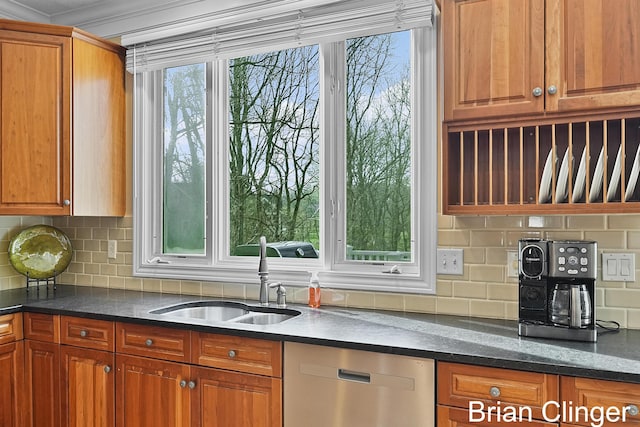 kitchen with decorative backsplash, brown cabinets, dishwasher, a sink, and dark stone countertops