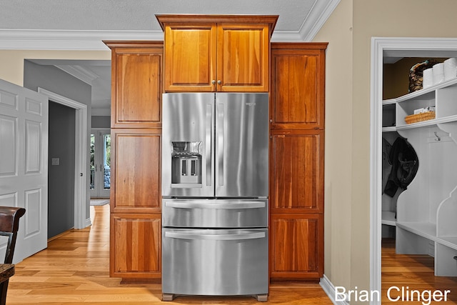 kitchen with crown molding, light wood-style flooring, brown cabinets, and stainless steel fridge with ice dispenser