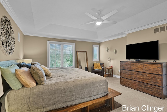 bedroom with carpet floors, a tray ceiling, visible vents, and ornamental molding