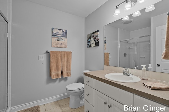 full bath featuring vanity, toilet, tile patterned floors, baseboards, and a shower stall