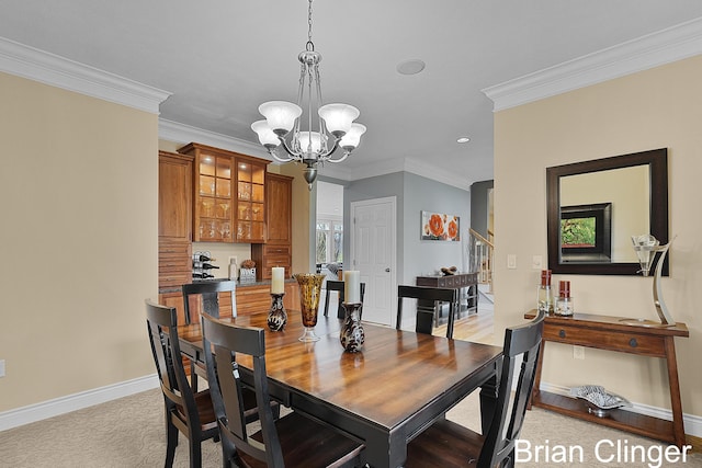 dining room with crown molding, recessed lighting, baseboards, and a chandelier