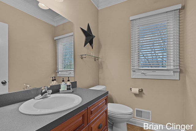 half bath with crown molding, toilet, visible vents, and vanity