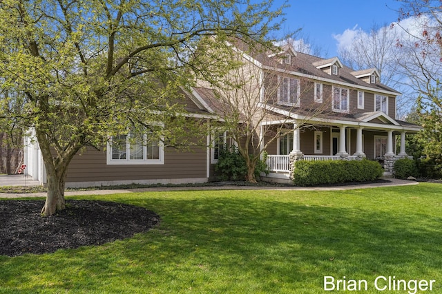 view of front of property featuring covered porch and a front lawn