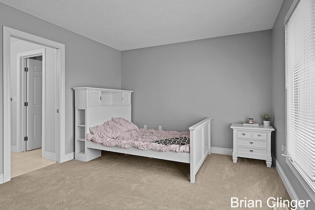 bedroom with baseboards, carpet flooring, and multiple windows