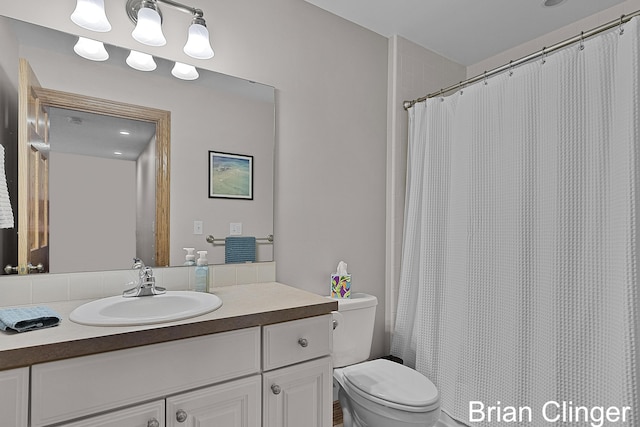 bathroom featuring vanity, toilet, and a shower with curtain