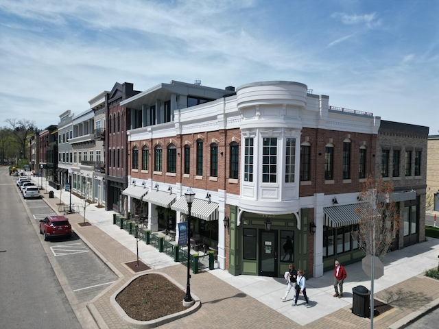 view of building exterior with uncovered parking