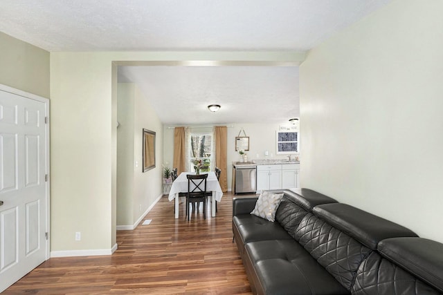 living area featuring baseboards and wood finished floors
