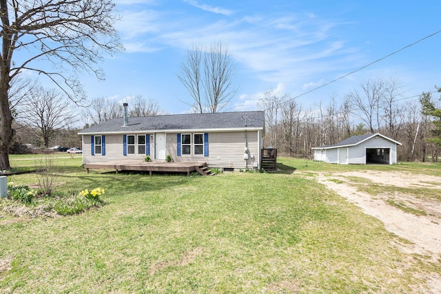view of front of house featuring a detached garage, an outbuilding, a wooden deck, and a front lawn