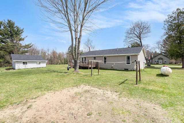 view of yard featuring a wooden deck and an outdoor structure