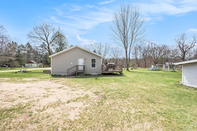 view of yard with a wooden deck and a playground