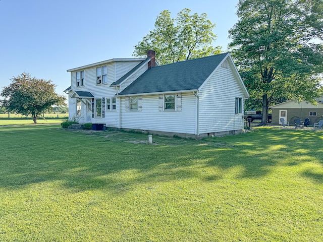 50002 M 51 N, Dowagiac, MI 49047 - back of house with a yard, central AC, a chimney, and roof with shingles