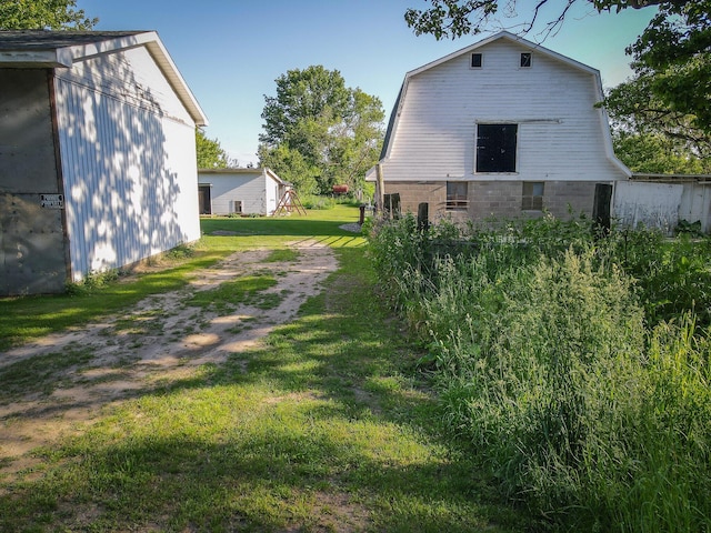 50002 M 51 N, Dowagiac, MI 49047 - view of side of property featuring a barn, a yard, and an outbuilding