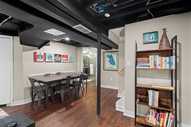 interior space with baseboards, visible vents, and wood finished floors