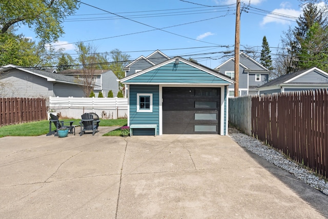 detached garage with fence and driveway