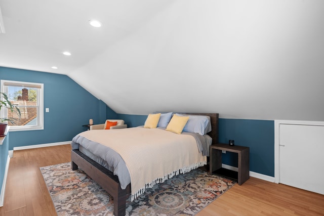 bedroom featuring baseboards, recessed lighting, lofted ceiling, and wood finished floors
