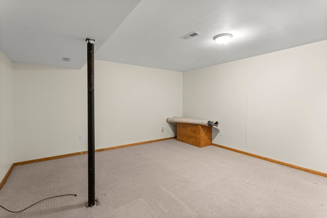 finished below grade area featuring carpet flooring, baseboards, and visible vents