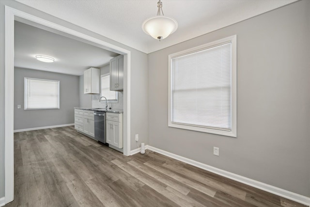 9119 Seminole, Redford, MI 48239 - kitchen with stainless steel dishwasher, baseboards, a sink, and dark wood-type flooring