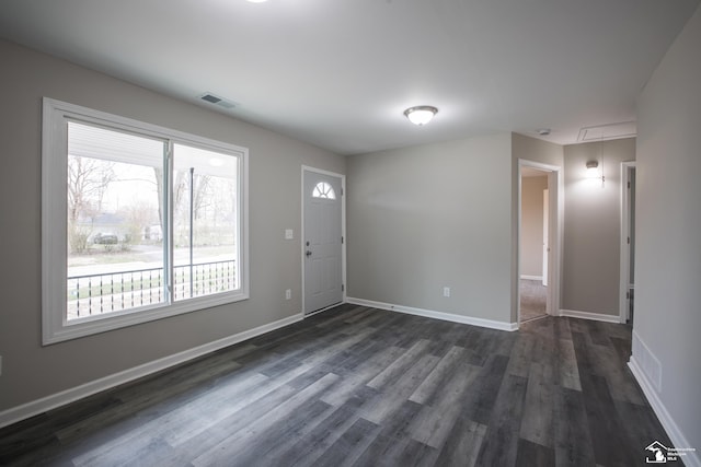 entryway with baseboards, visible vents, and dark wood finished floors