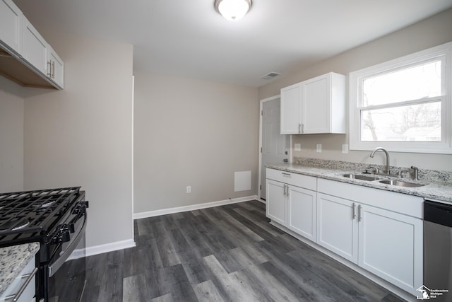 kitchen with visible vents, light stone countertops, dark wood-style floors, a sink, and dishwasher