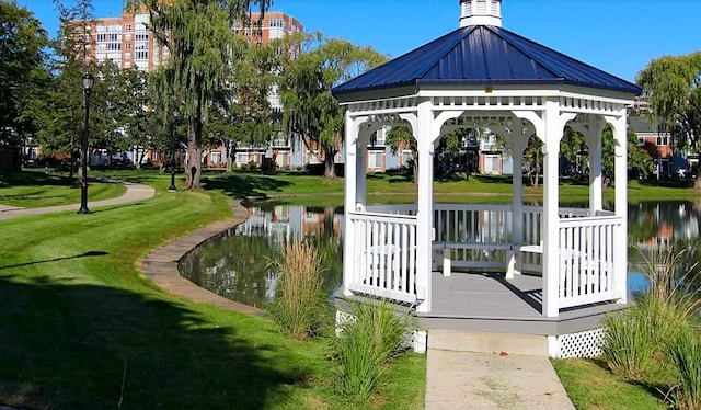 view of community featuring a gazebo, a water view, and a lawn