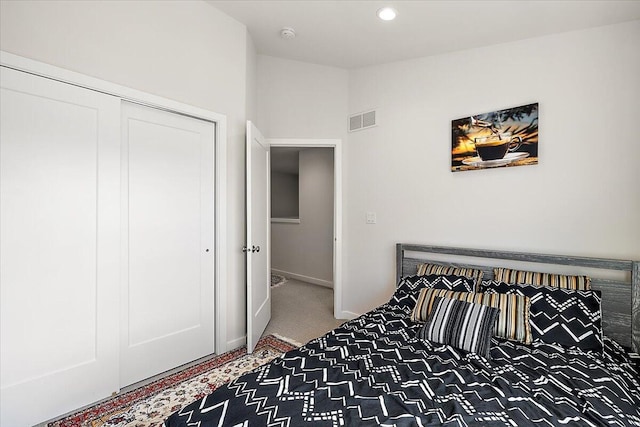 carpeted bedroom with visible vents, baseboards, a closet, lofted ceiling, and recessed lighting