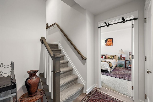 stairs featuring baseboards and wood finished floors