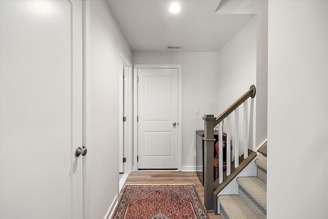 interior space with baseboards, light wood-style flooring, and visible vents